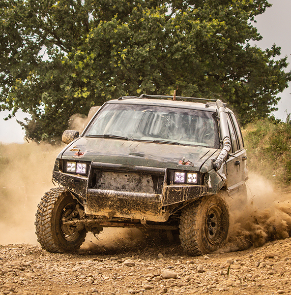 Truck racing on dirty road.